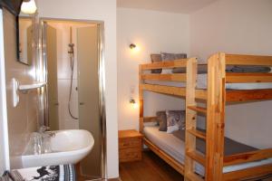 a bathroom with a bunk bed and a sink at Haus Tannenblick in Saalbach Hinterglemm