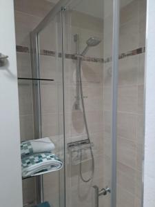 a shower with a glass door in a bathroom at Studio Dinard in Dinard