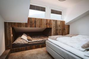 a bedroom with two beds and a fireplace at Panorama Lodge Edelweiss in Gosau