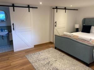 a bedroom with a bed and a large sliding door at Wood Lodge in Bungay