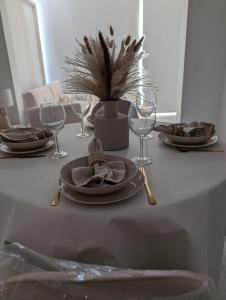 a table with plates and wine glasses on it at Alalba in Benidorm