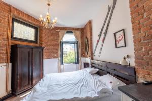 a bedroom with a bed and a brick wall at Barrique 14 - Breakfast at Restaurant & Minibar - Old Town in Braşov