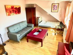 a living room with a couch and a table at Apartment to Düsseldorf - near Airport DUS - Trade Fair - Arena in Düsseldorf