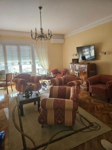 a living room with couches and chairs and a television at Aurelia in Vinkovci