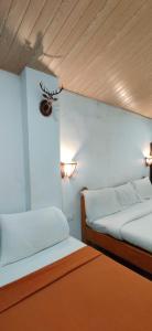 Postel nebo postele na pokoji v ubytování Hotel MJ Beach Resort Baga