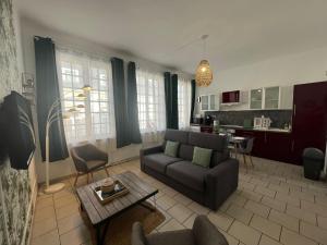 a living room with a couch and a table at L'Oasis Arrageoise 45m2 4 personnes hyper centre in Arras +14 photos