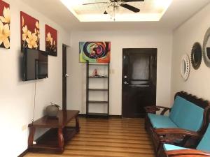a living room with a couch and a table at Apong Martina's Guest House La Union in Lacong