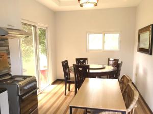 a kitchen and dining room with a table and chairs at Apong Martina's Guest House La Union in Lacong