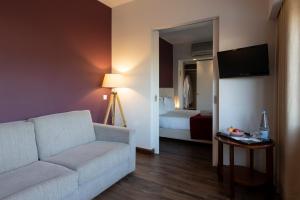 a living room with a couch and a bed at Hotel Rali Viana in Viana do Castelo
