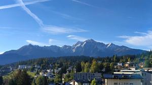 a view of a city with mountains in the background at Hotel-Restaurant Bellevue in Flims