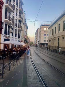 a group of people walking down a street with train tracks at Suite Beethoven in Santa Cruz de Tenerife