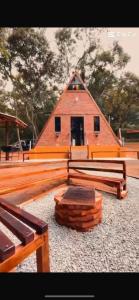 a large wooden building with a roof at Cabaña Tu Lugar Favorito in Santa Elena +4 photos