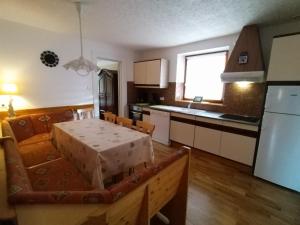 a kitchen with a table and a dining room at maison de vacances chez louis in Sondernach +15 photos