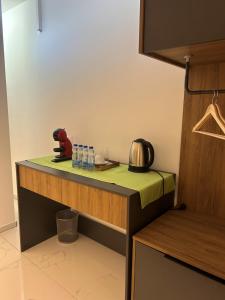 a kitchen with a counter with bottles of water at Comfort Hotel in Struga