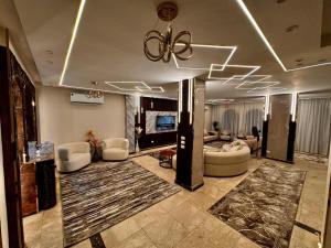 a large living room with couches and a ceiling at فيلا إيجار في التجمع الخامس Vip Luxury home in Cairo +10 photos