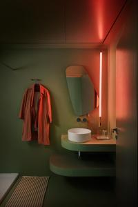 a bathroom with a sink and a mirror at Chic & Cheeky Reside in Malta's Tallest Skyscraper in St Julian's