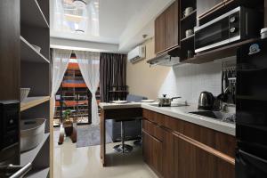 a kitchen with a sink and a counter top at 1bdr Apartment Naiharn Beach Condo by CapitalPro in Phuket Town