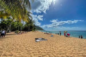 people on a beach with a kite on the sand at Bungalow JOK'MI in Pointe-Noire +3 photos