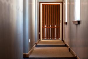 an empty corridor with a door in a building at Hotel Rali Viana in Viana do Castelo