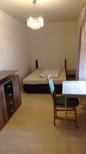 a room with a bed and a chair and a table at Gästewohnung Sommer Locktow, Hauptstraße 1 in Locktow