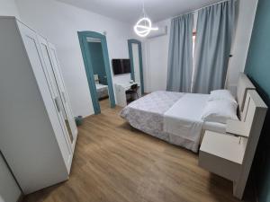 a bedroom with a bed and a large mirror at Il Giramondo in Aversa +10 photos