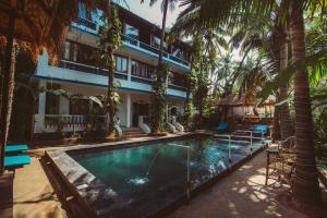 a hotel with a swimming pool in front of a building at Nalanda Retreat Goa By Mandrem Beach in Mandrem