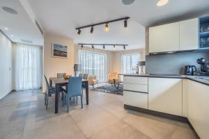 a kitchen and dining room with a table and chairs at Dolce Pieta' Penthouse in Pieta