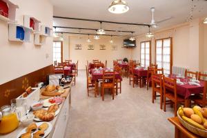 a restaurant with tables and chairs with food on them at Sierra de Arbe in Naval