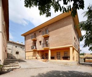 a large brick building with balconies on it at Sierra de Arbe in Naval