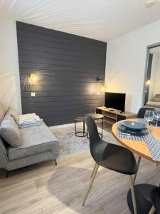 a living room with a couch and a table at Souleih d Ossau 203 in Bielle +28 photos