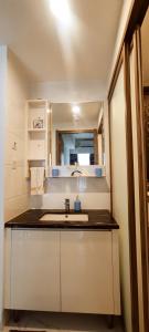 a small kitchen with a sink and a mirror at 2BR Skyhouse Jervois - Perfect for ICE BSD Events in Cilenggang