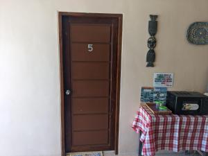a door in a room with a table with a tablecloth at Francis Dale Lodge L5 in El Nido