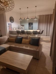 a living room with a couch and a table at Perpignan Villa climatisée 4 personnes in Pia +6 photos