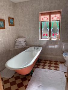 a bathroom with a tub and a toilet and a window at The School House, Ironbridge in Ironbridge