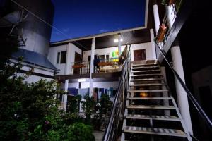 a staircase leading up to a building at night at Гостевой Дом В Гостях на Иссык-Куле in Cholpon-Ata