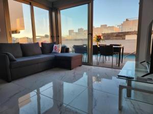 a living room with a couch and a table at Fee4Me Villa, Pool, Roofterrace & Relax in Alicante