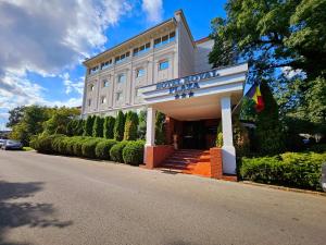 a hotel with a sign on the side of a road at Hotel Royal Plaza By TimHotels in Timişoara