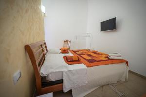 a bedroom with a bed with a flat screen tv at Apulia lux in Taranto