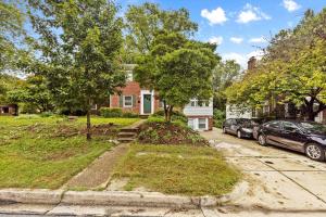 a house with two cars parked in the driveway at Cozy 1-bedroom garden apartment in Silver Spring