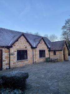 a large stone building with a bench in front of it at The School House, Ironbridge in Ironbridge
