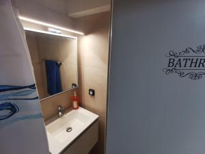 een badkamer met een wastafel en een spiegel bij GardenHouse in Athene