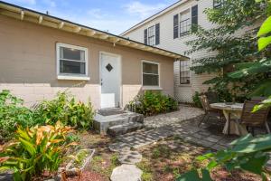 a backyard with a table and a white door at Walkable Duplex Near Forsyth Park in Savannah