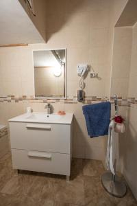 a bathroom with a white sink and a mirror at Casa bea in Taranto