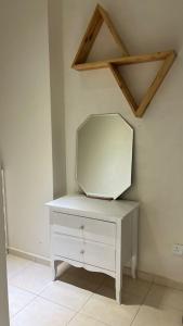 a white dresser with a mirror on top of it at Kiki's room for men 8B in Melaka
