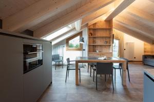 a kitchen and dining room with a table and chairs at BAITA LARIX Sauna&Relax in Bormio