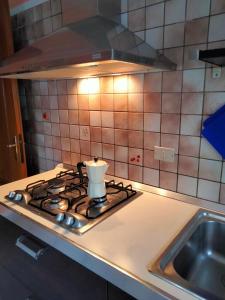 a candle sitting on top of a stove in a kitchen at appartamento signorile con giardino in Aosta