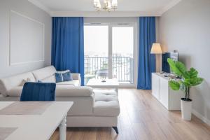 a living room with a couch and a table at Apartament Glamour in Gdańsk