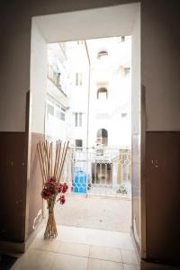 an open door with a vase of flowers in a room at the Lighthouse accommodation in Taranto