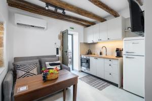 a kitchen with a table with a bowl of fruit on it at Sitia Sandali elia apartment in Epáno Dhris
