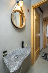 a bathroom with a marble sink and a mirror at Sitia Sandali elia apartment in Epáno Dhris